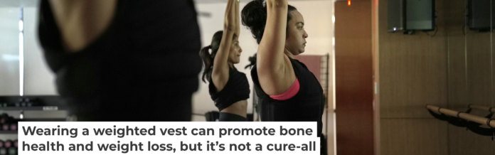Jannelliz Barragan, center, wears a weighted vest during a workout class in New York on Aug. 13, 2025. AP Photo/Shelby Lum